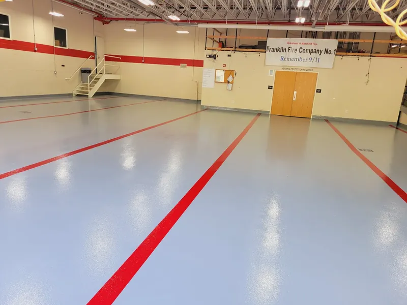 Gray epoxy firehouse floor with red bay lines
