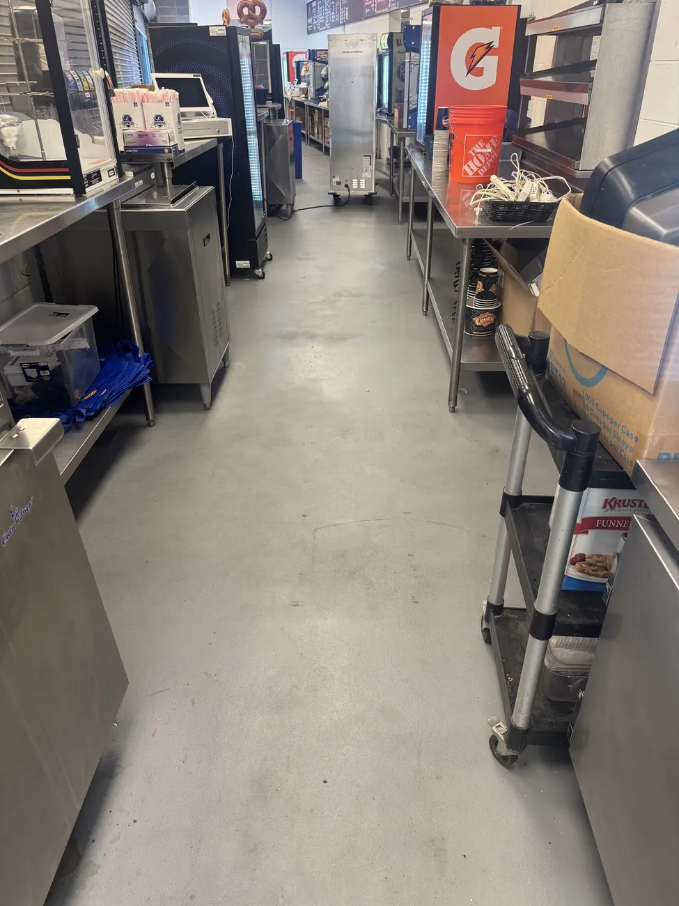 Gray seamless floor in a commercial kitchen service corridor