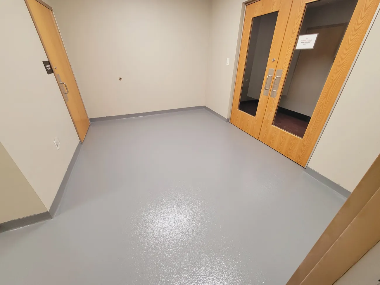 Gray epoxy floor in an office with double doors