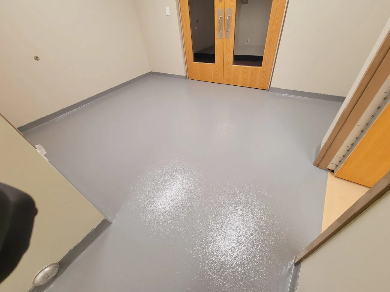 Gray epoxy floor meeting a doorway threshold