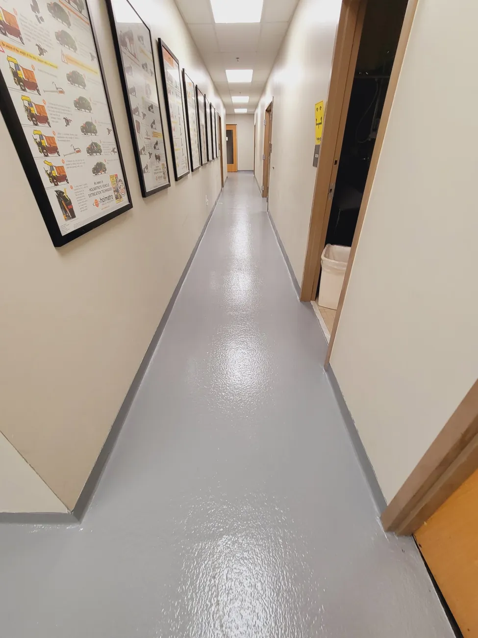 Corridor with framed pictures and a gray epoxy floor