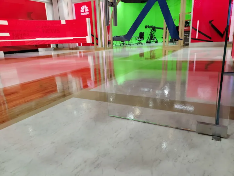 Clear coated Today Show studio floor reflecting the red set walls and NBC logos