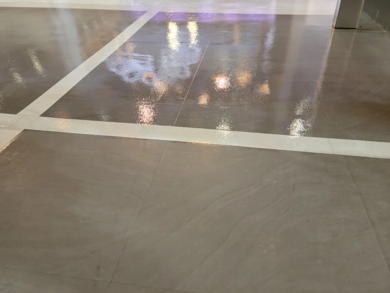 Clear coat over crossing inlay lines, reflecting the studio lights