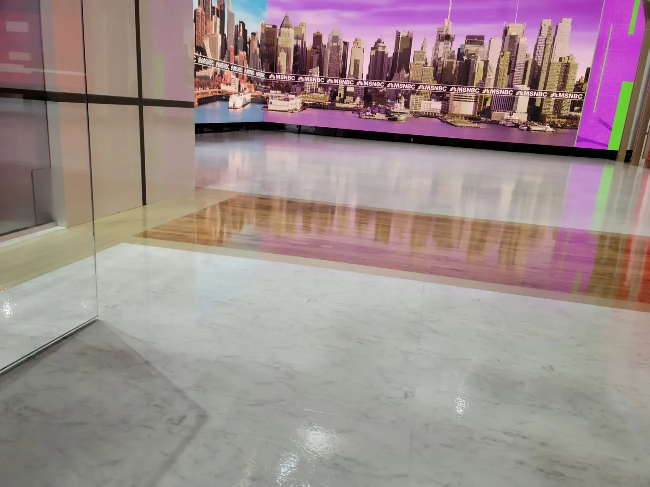 Clear coated studio floor reflecting a city skyline backdrop