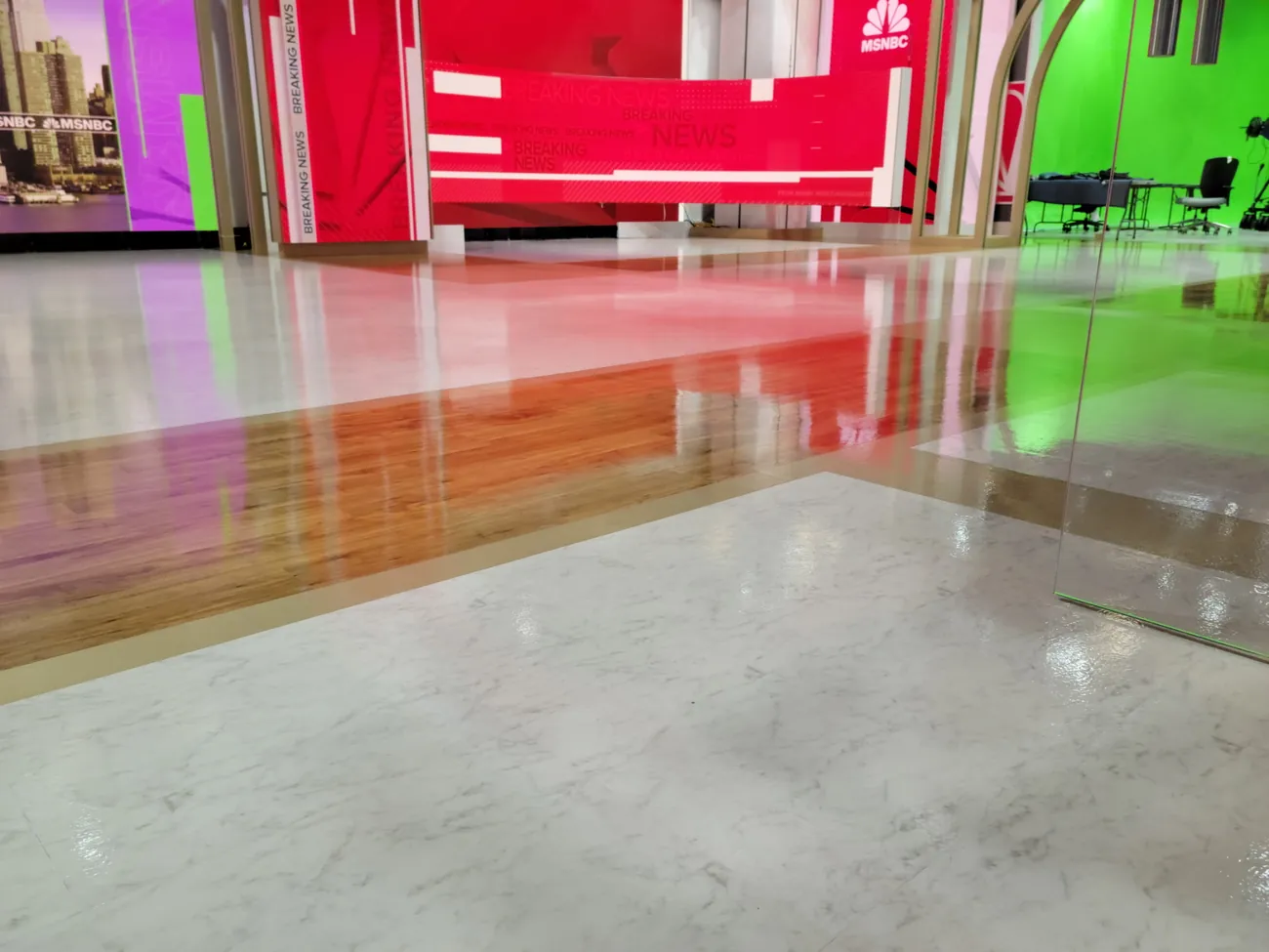 Glossy studio floor reflecting red and green set walls
