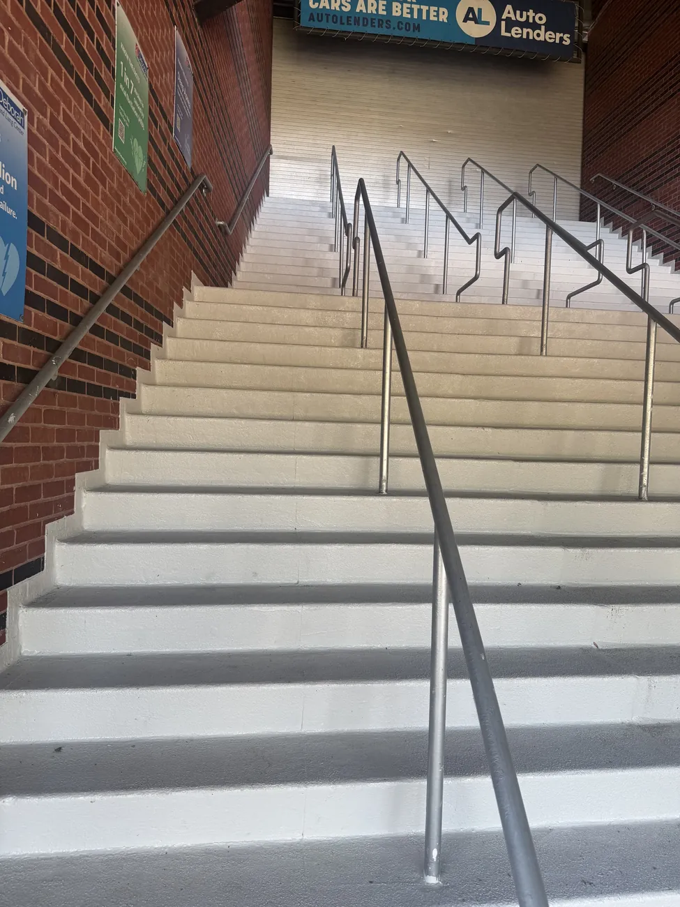 Coated stadium stairs with handrails
